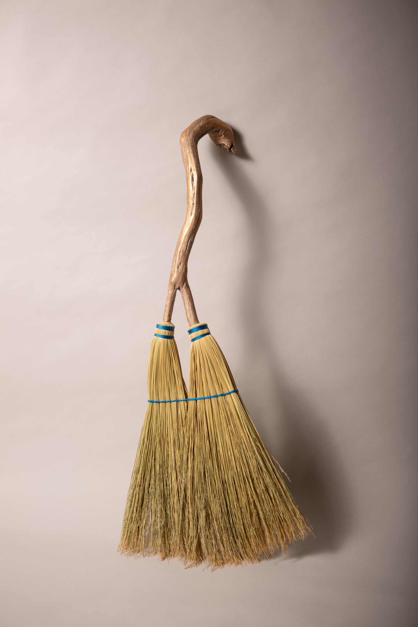 Double headed broom on driftwood forked handle blue twine natural broomcorn hand crafted